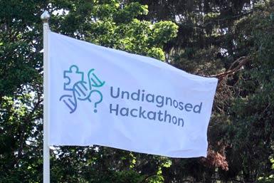 Vit flagga med texten Undiagnosed Hackathon och logo
